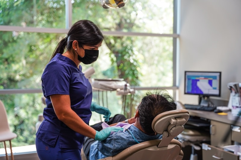 Same Day Smiles staff member caring for patient.
